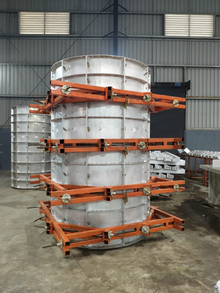 A circular aluminium column box with orange steel walers in the Navkaar factory
